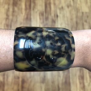 Tory Burch cuff bracelet with engraved logo.